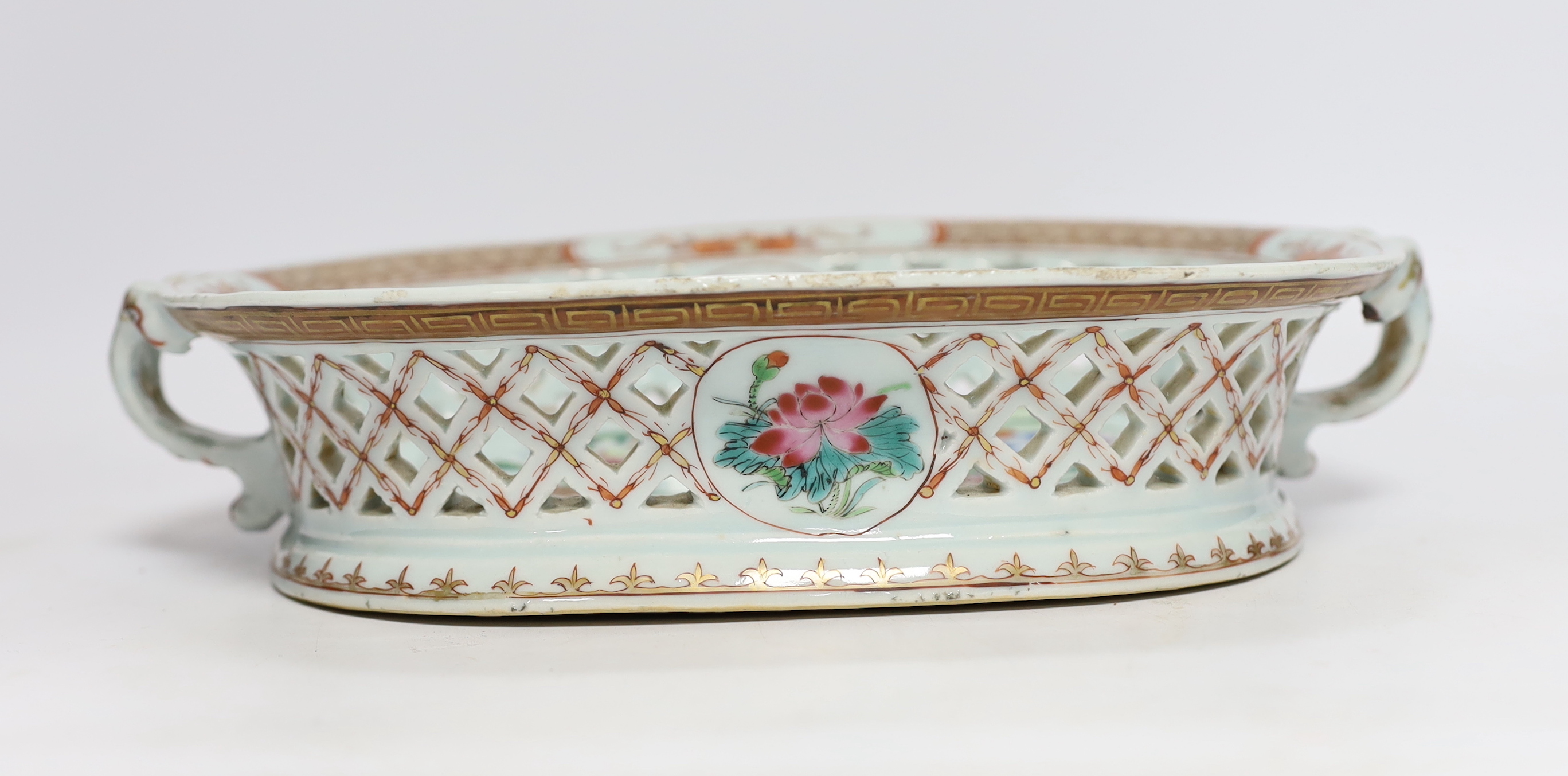 A Chinese famille rose basket with pierced decoration and twin handles, Qianlong period, 31cm wide